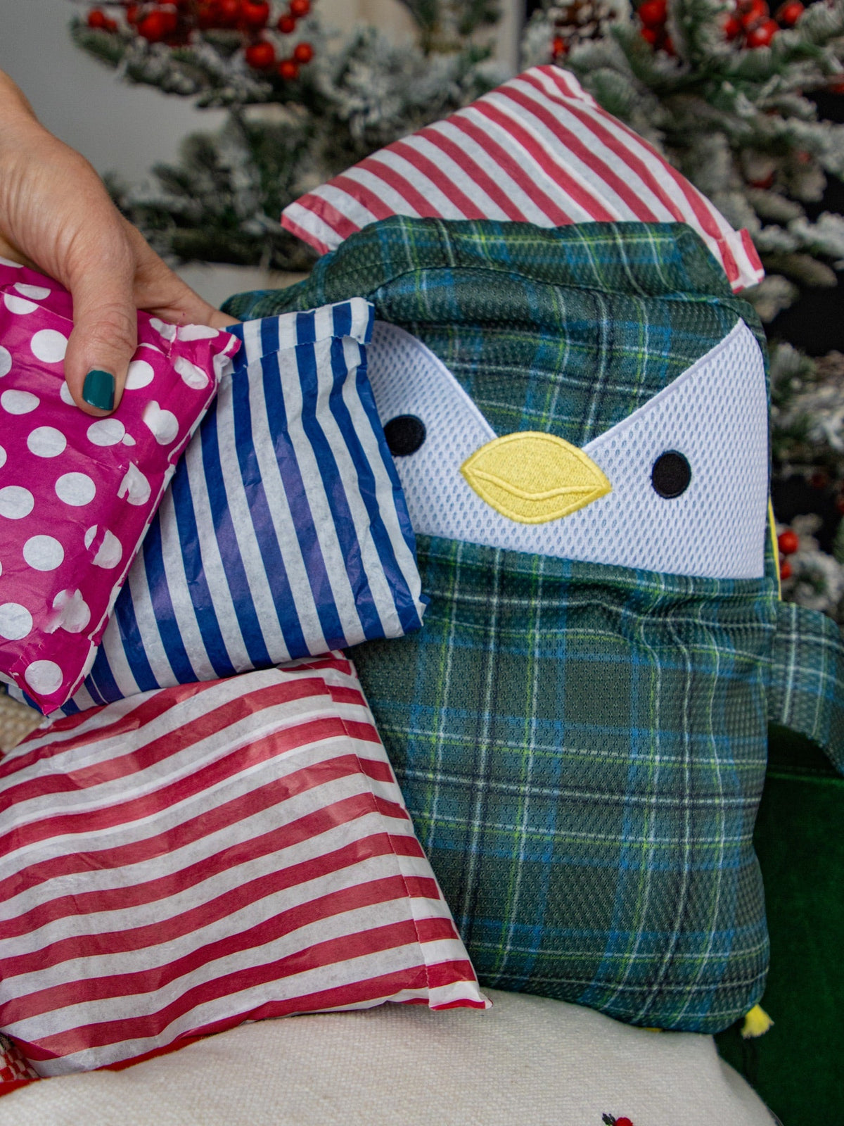 A pile of wrapped mystery parcels next to Scotch the penguin washbag